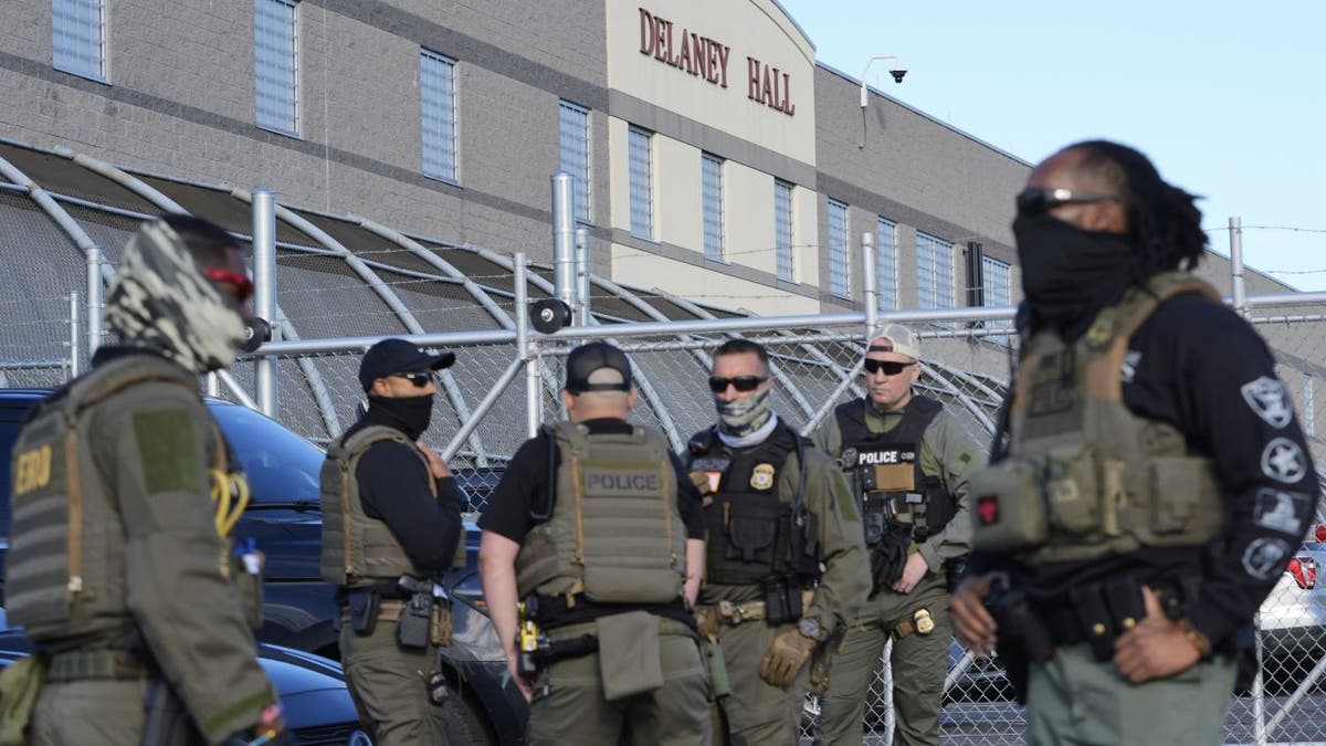 Security personnel stand in front of Delaney Hall, a recently re-opened immigration detention center, in Newark, N.J., Wednesday, May 7, 2025. (AP Photo/Seth Wenig)