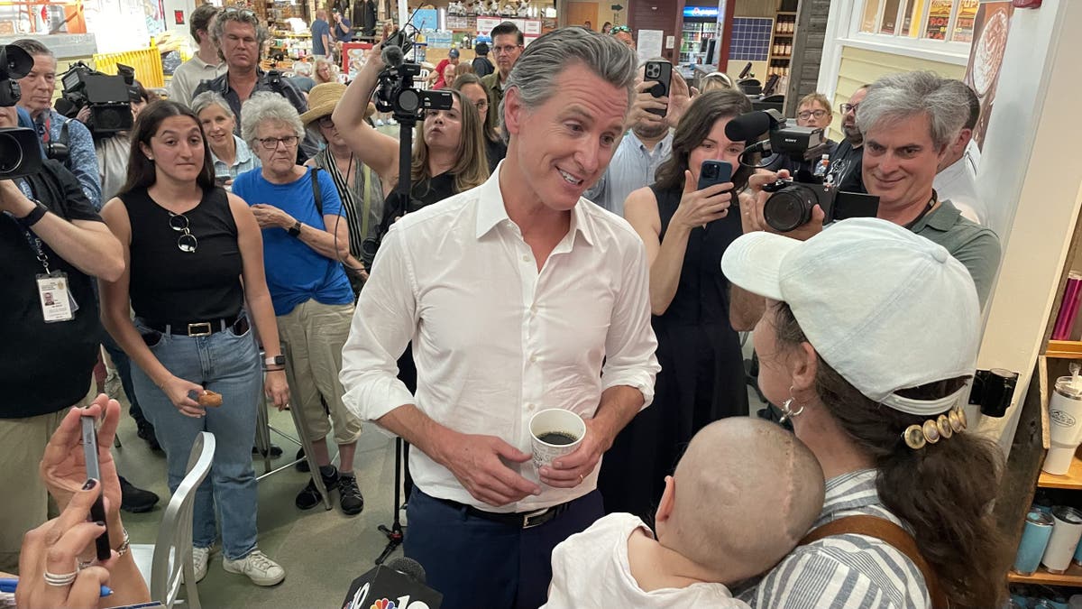 Democratic California Gov. Gavin Newsom speaks with voters during a stop