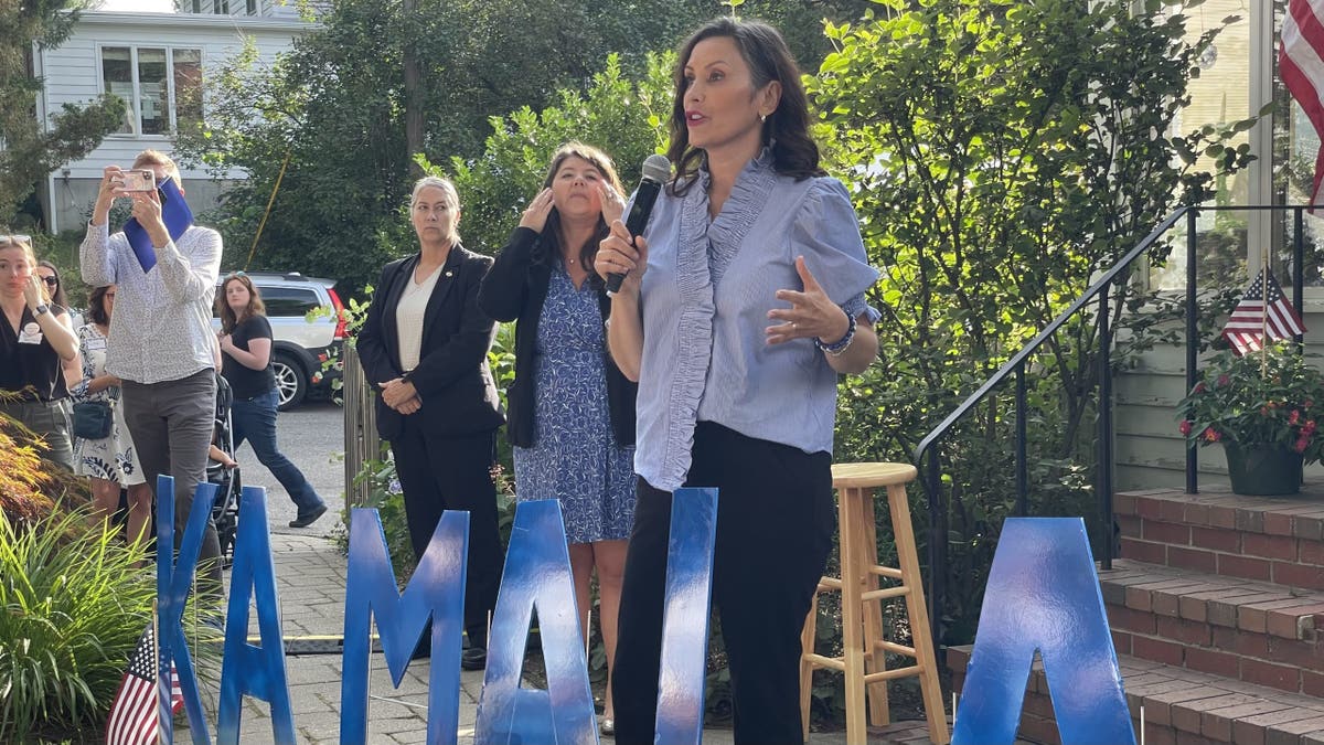 Gretchen Whitmer campaigning outside with a microphone
