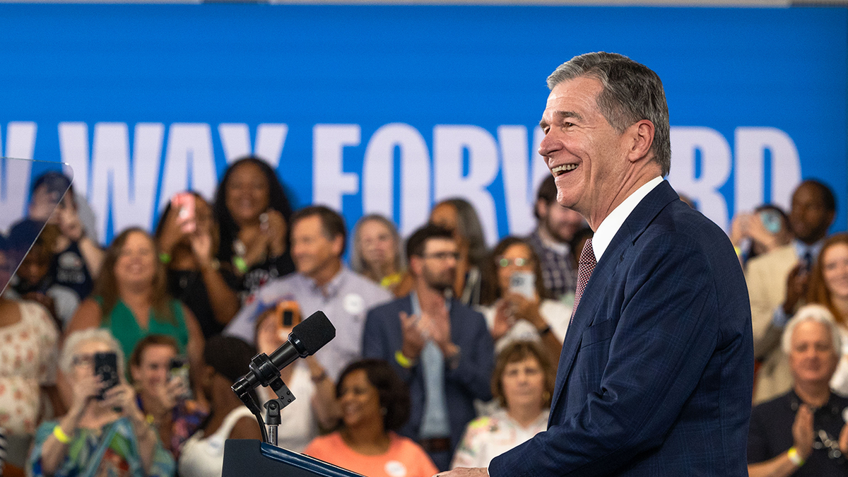 Gov. Roy Cooper speaking to a group of people at a podium