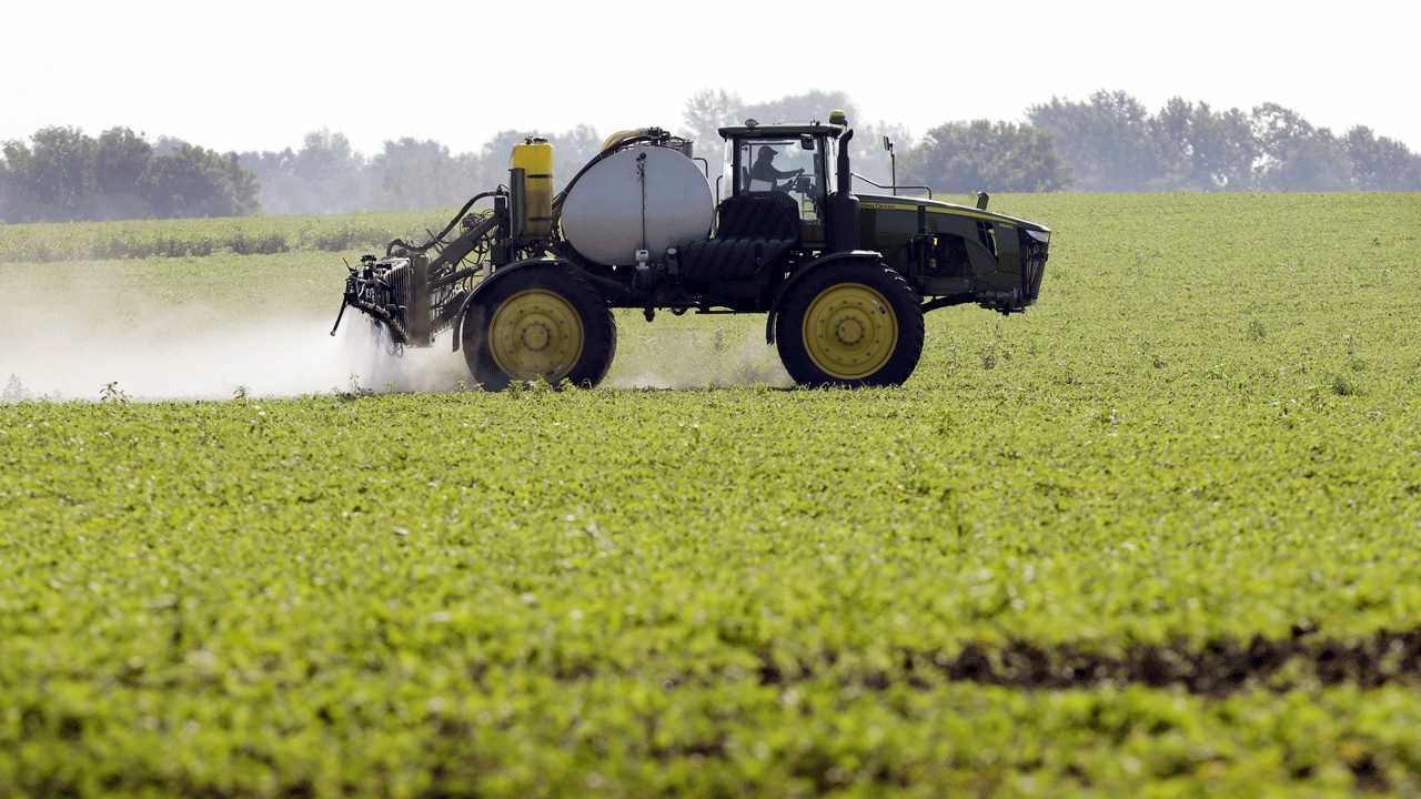 machine spraying pesticide in field