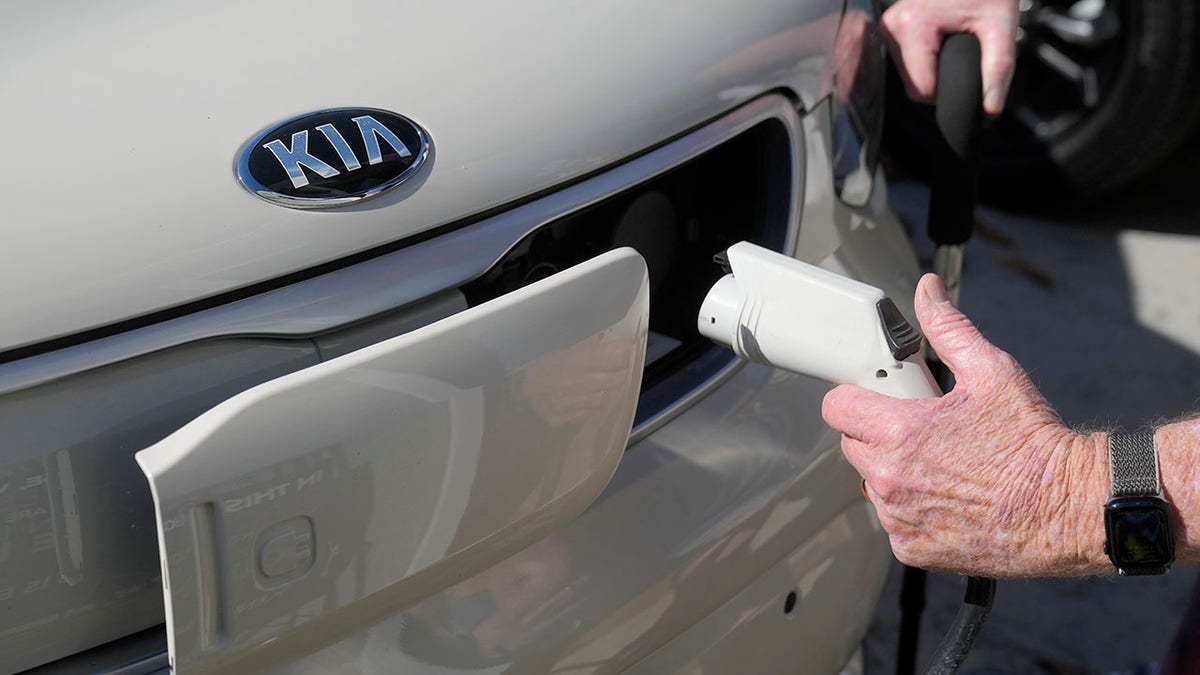 A KIA being charged
