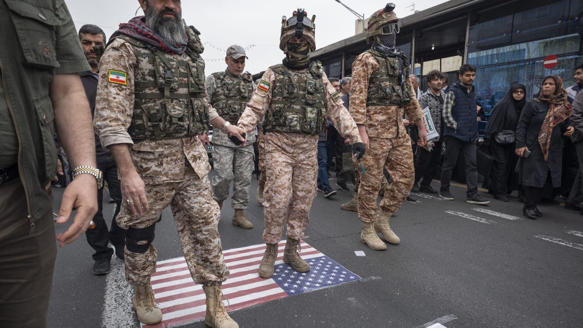 Islamic Revolutionary Guard Corps (IRGC) Special forces walk on the U.S. flag during a rally commemorating International Quds Day, also known as Jerusalem Day, in Tehran, Iran, on March 28, 2025.