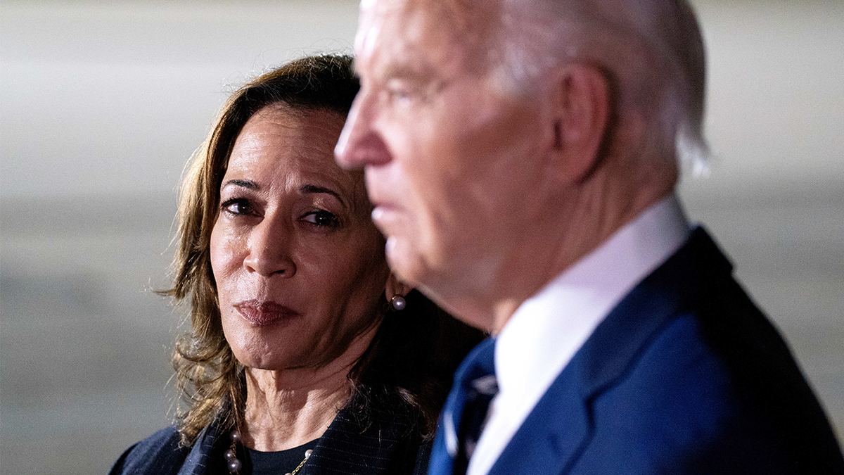 Former Vice President Kamala Harris watches as former President Joe Biden speaks to members of the media at Joint Base Andrews, Maryland, on Thursday, Aug. 1, 2024.