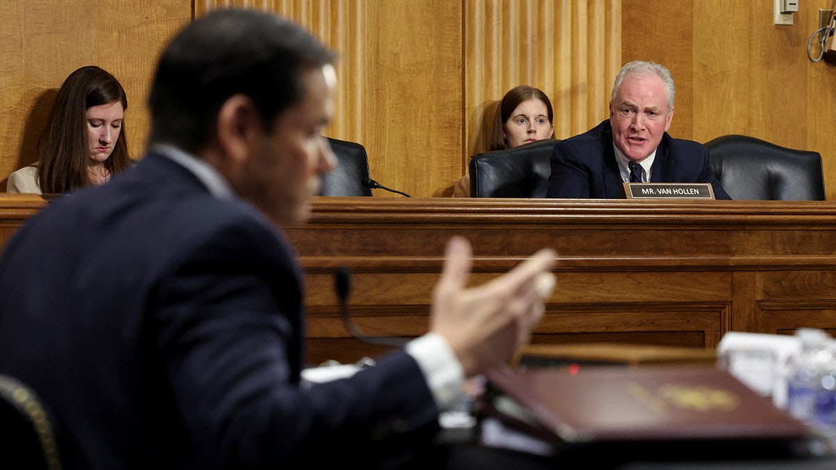 Sen. Chris Van Hollen speaks while Secretary of State Marco Rubio gestures