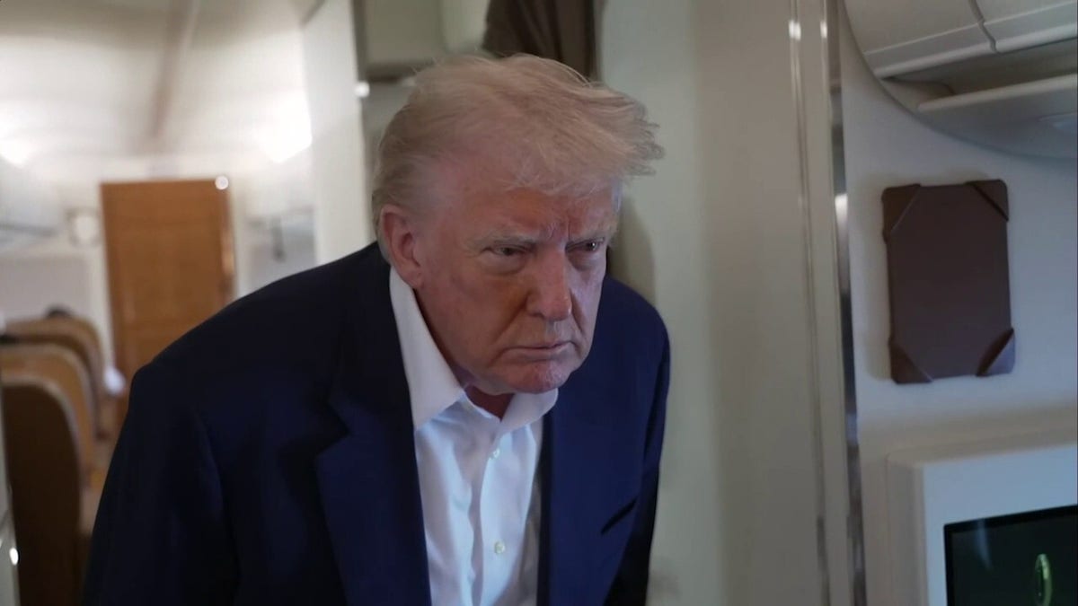 Trump speaks to reporters on Air Force One