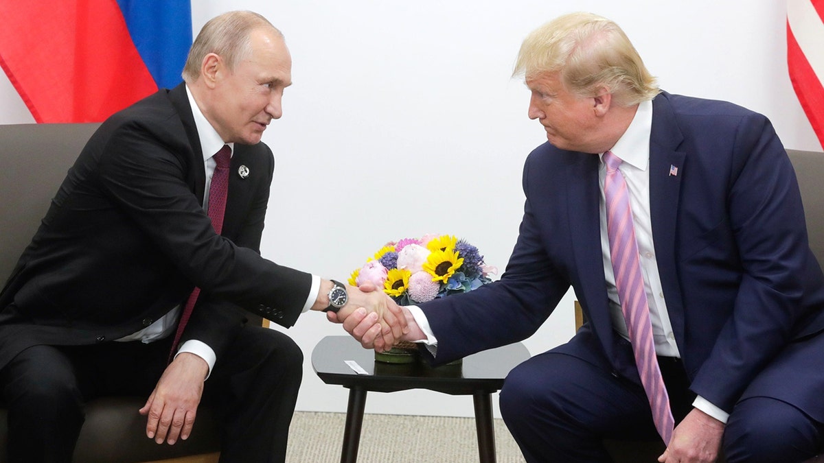 Trump shakes hands with Putin