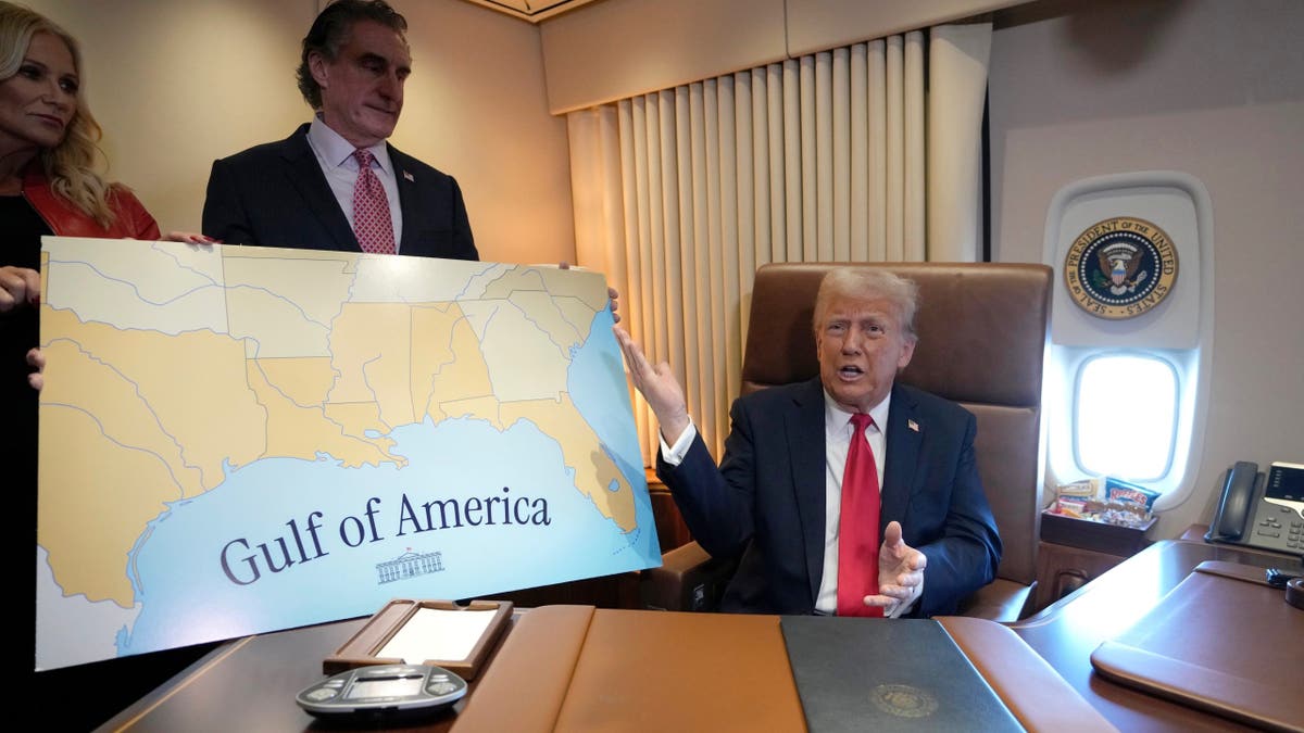 President Donald Trump, right, speaks to reporters accompanied by Interior Secretary Doug Burgum and Burgum's wife Kathryn Burgum, aboard Air Force One, where Trump signed a proclamation declaring Feb. 9 Gulf of America Day.