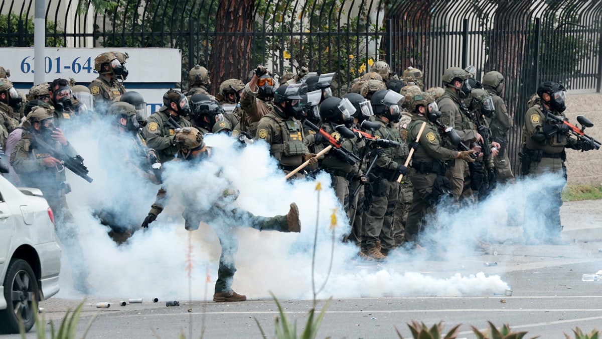 Police kicking tear gas