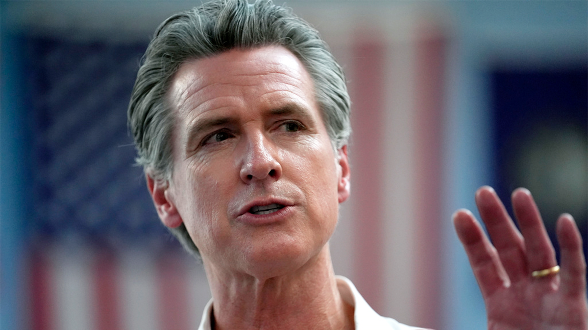 California Gov. Gavin Newsom with an American flag in the background