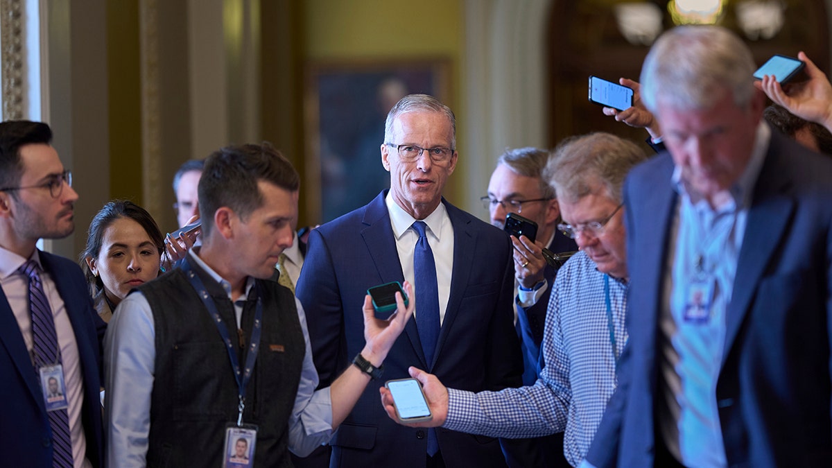 Thune walks with reporters