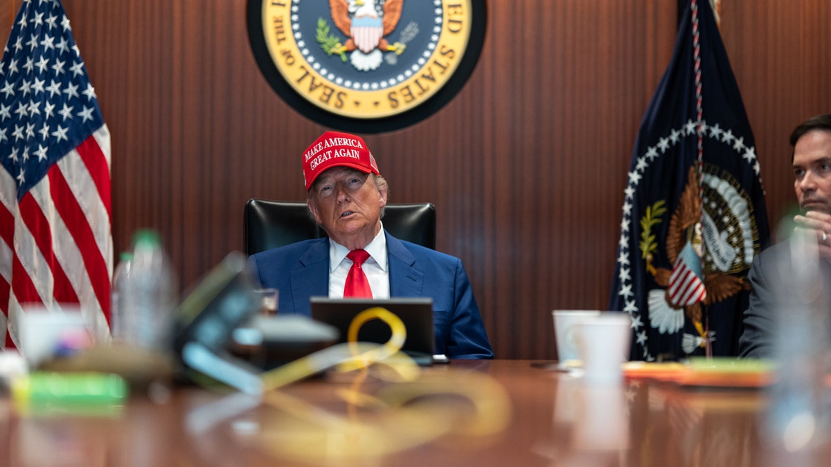 President Trump wearing a MAGA hat in the Situation Room