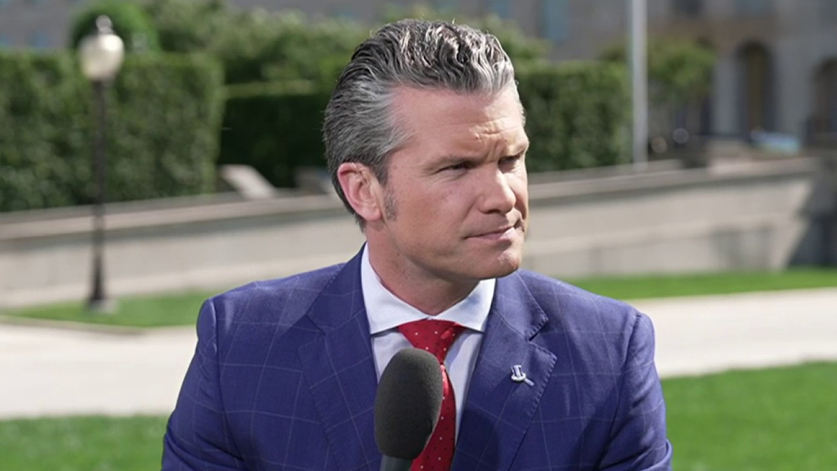 Pete Hegseth at a microphone outside