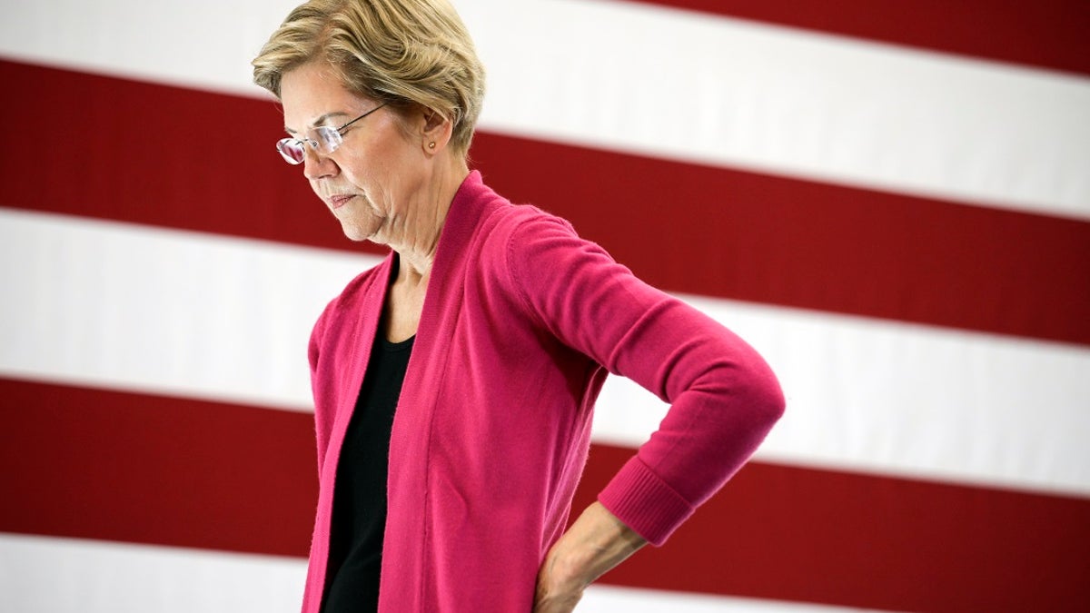 Sen. Warren closeup shot, large US flag behind her