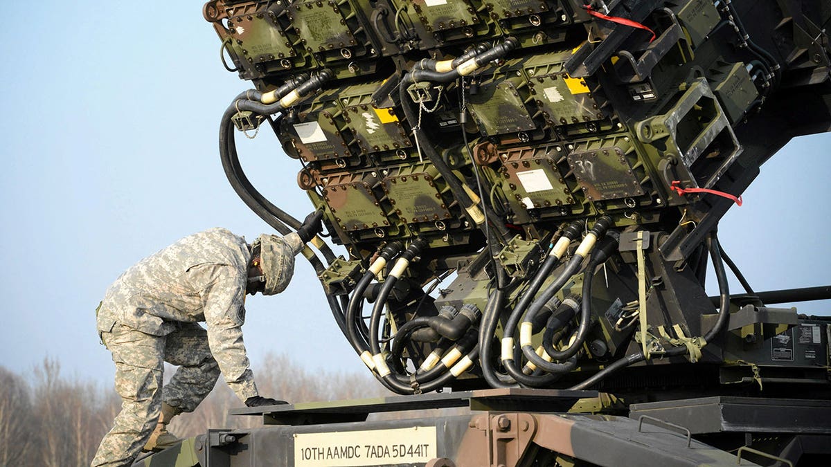 A U.S soldier inspects a Patriot missile defense battery during join exercises at military grounds in Sochaczew, near Warsaw, on March 21, 2015.