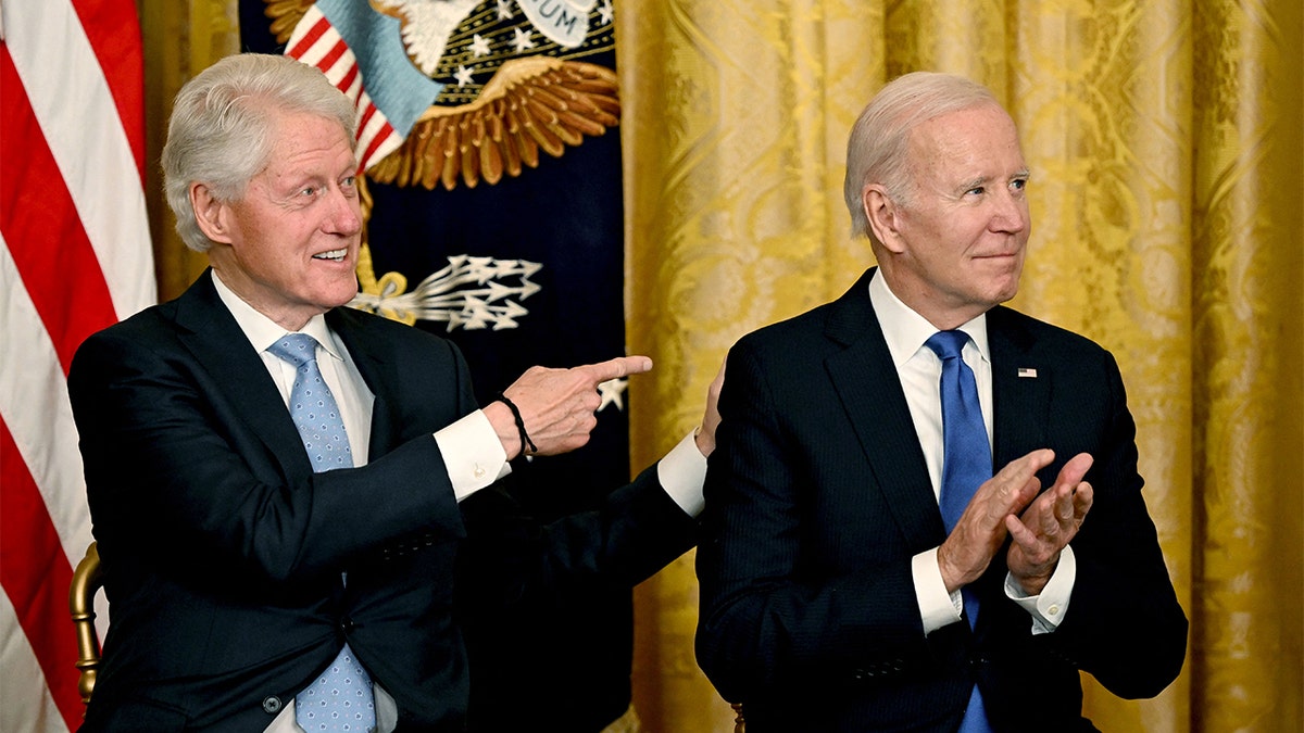 Bill Clinton left, points at Joe Biden