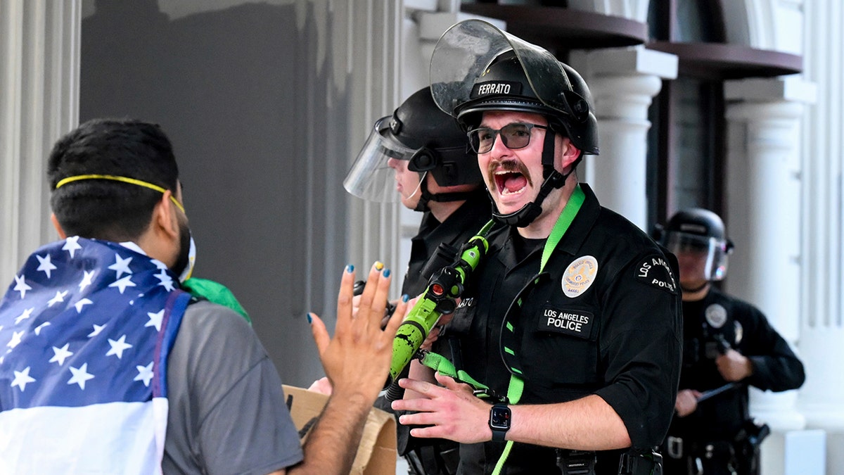 LAPD officer appears to yell at rioter