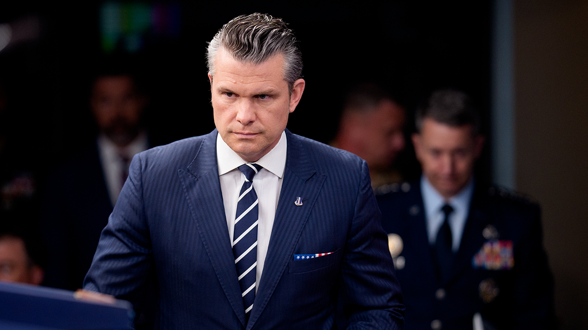 Pete Hegseth walking to news conference