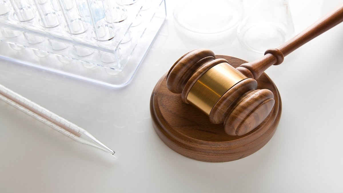 gavel on table stock image with test tubes