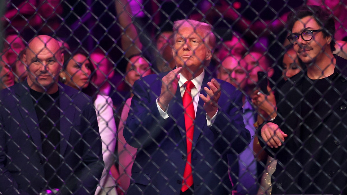 Trump applauds while standing next to Dana White at UFC 316