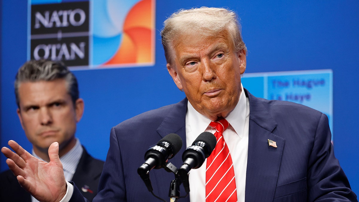 Trump speaks into the mic at NATO press conference