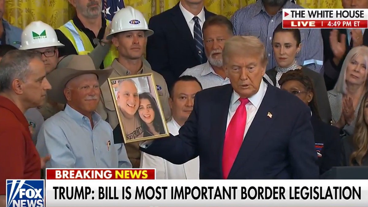 Trump with photo of slain woman