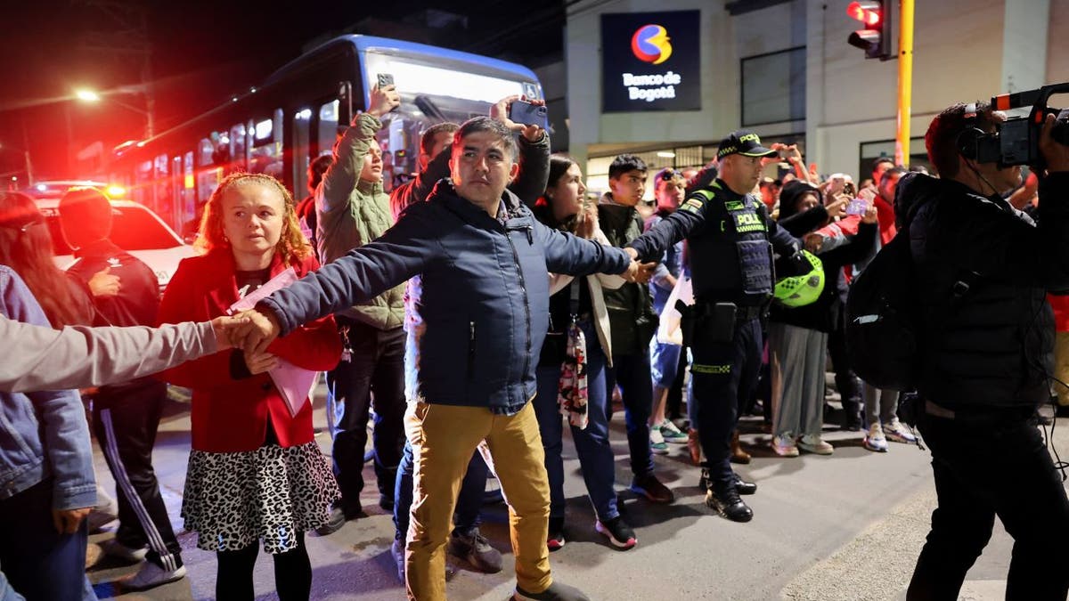 People clear the way for the ambulance carrying Miguel Uribe after he was shot on June 7, 2025.