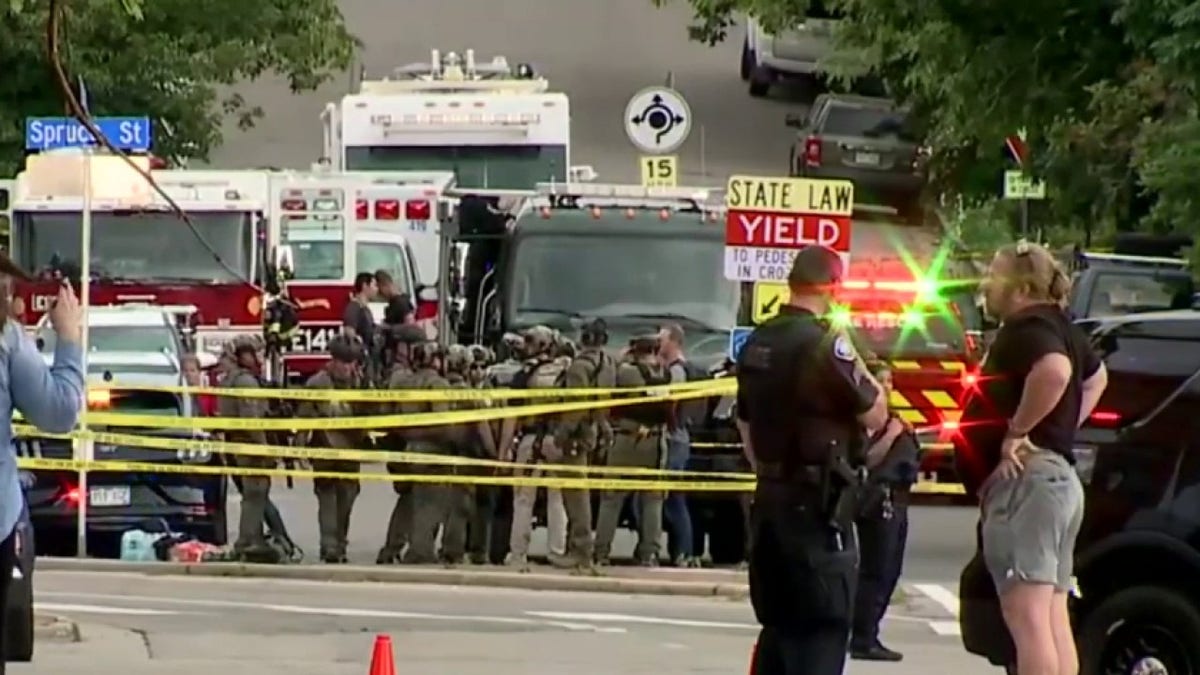 police line, vehicles behind it in Boulder