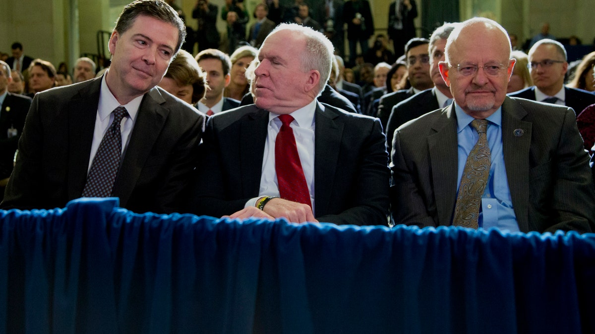 From left, FBI Director James Comey, CIA Director John Brennan, and Director of National Intelligence James Clapper sit together in the front row before President Barack Obama spoke about National Security Agency (NSA) surveillance, Friday, Jan. 17, 2014, at the Justice Department in Washington. The president called for ending the government's control of phone data from millions of Americans. (AP Photo/Carolyn Kaster)