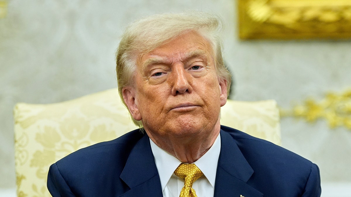 Trump in the Oval Office with a serious face