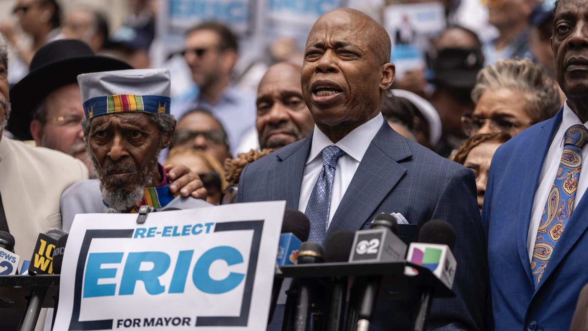 Mayor Eric Adams at lectern at campaign rally