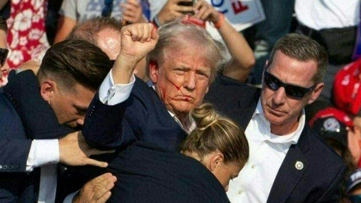 President Donald Trump is surrounded by Secret Service after being shot in Butler, Pennsylvania.