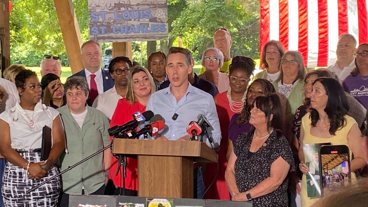 Sen. Josh Hawley stands with supporters after passing the Radiation Exposure Compensation Act.