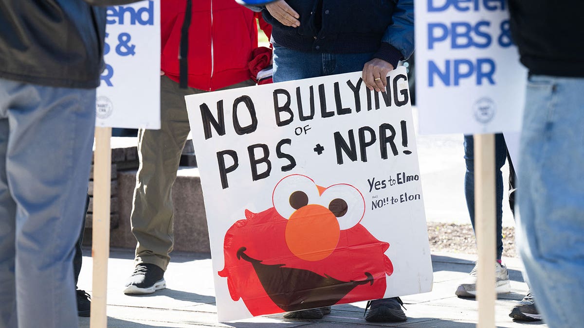 People participate in a rally to call on Congress to protect funding for public broadcasters outside the NPR headquarters in Washington, DC.