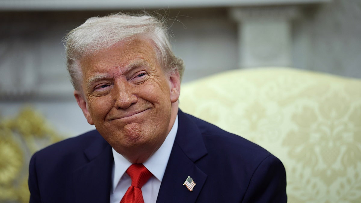 President Donald Trump grins