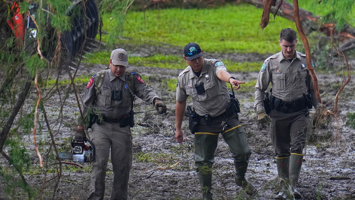 Emergency workers search through rubble to find missing people after flash flood.