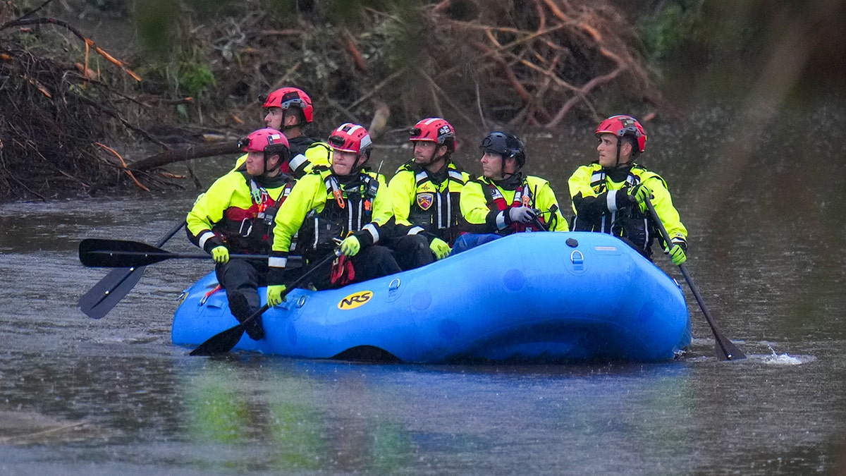 Emergency workers search through rubble to find missing people after flash flood.