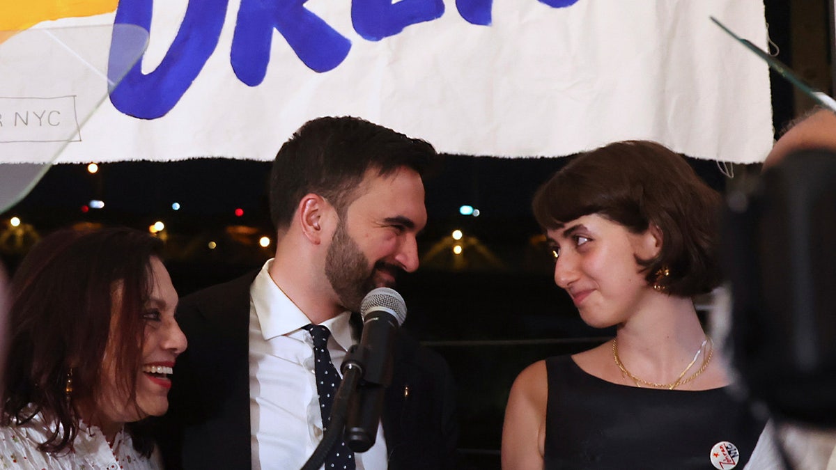 Zohran Mamdani appears on stage with his family including his wife, Rama Duwaji, right