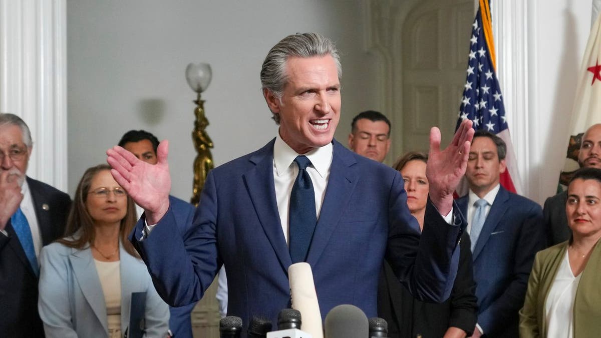 California Gov. Gavin Newsom, center, discusses the push to schedule a special election to redraw California's Congressional voting districts