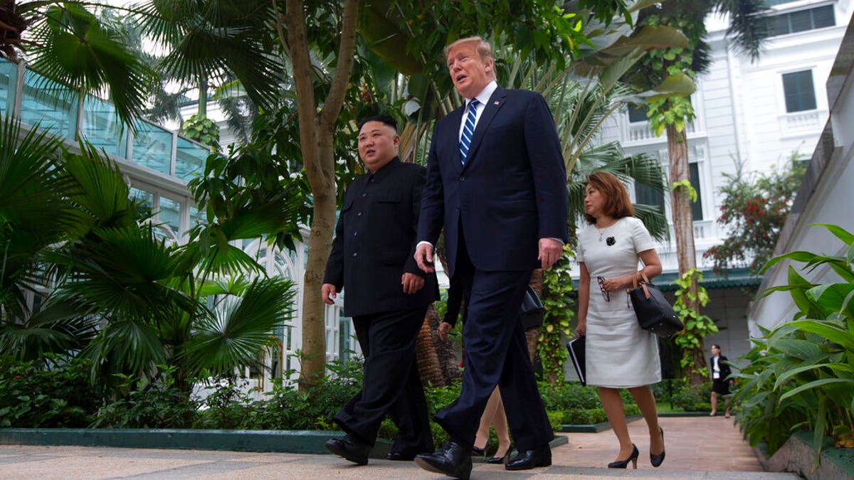 President Donald Trump and North Korean leader Kim Jong Un take a walk after their first meeting at the Sofitel Legend Metropole Hanoi hotel, Feb. 28, 2019, in Hanoi. (Evan Vucci/The Associated Press)