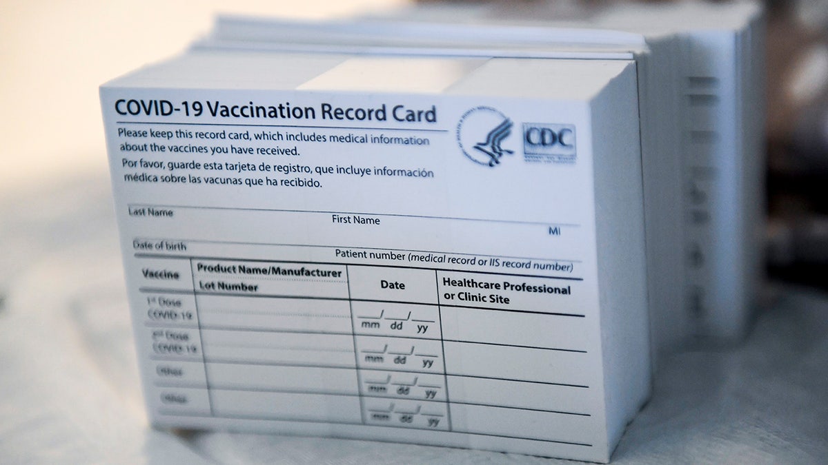 A stack of COVID-19 Vaccination Record Cards from the CDC. 