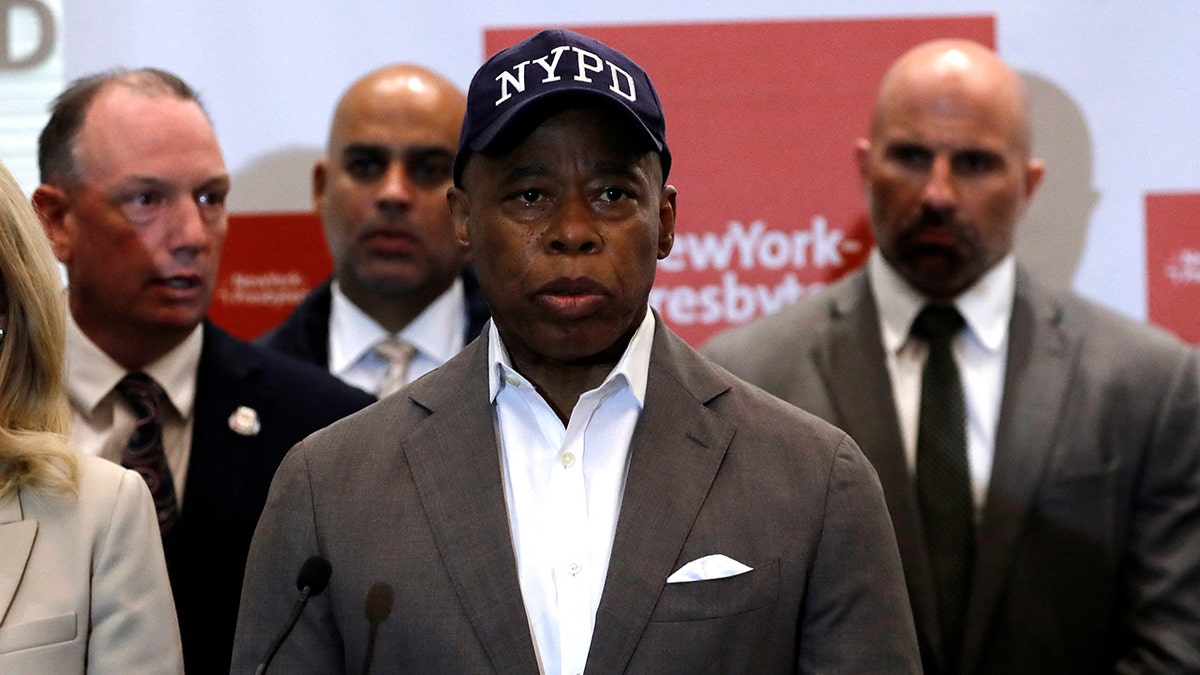 Mayor Eric Adams in black hat with white NYPD letters