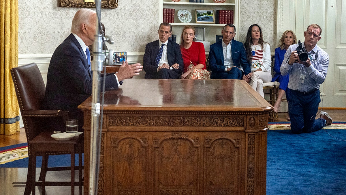 Ashley Biden sitting with her husband listening to her father give a live address in the Oval Office
