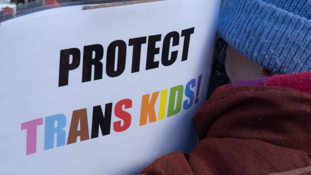 A "Protect Trans Kids" sign