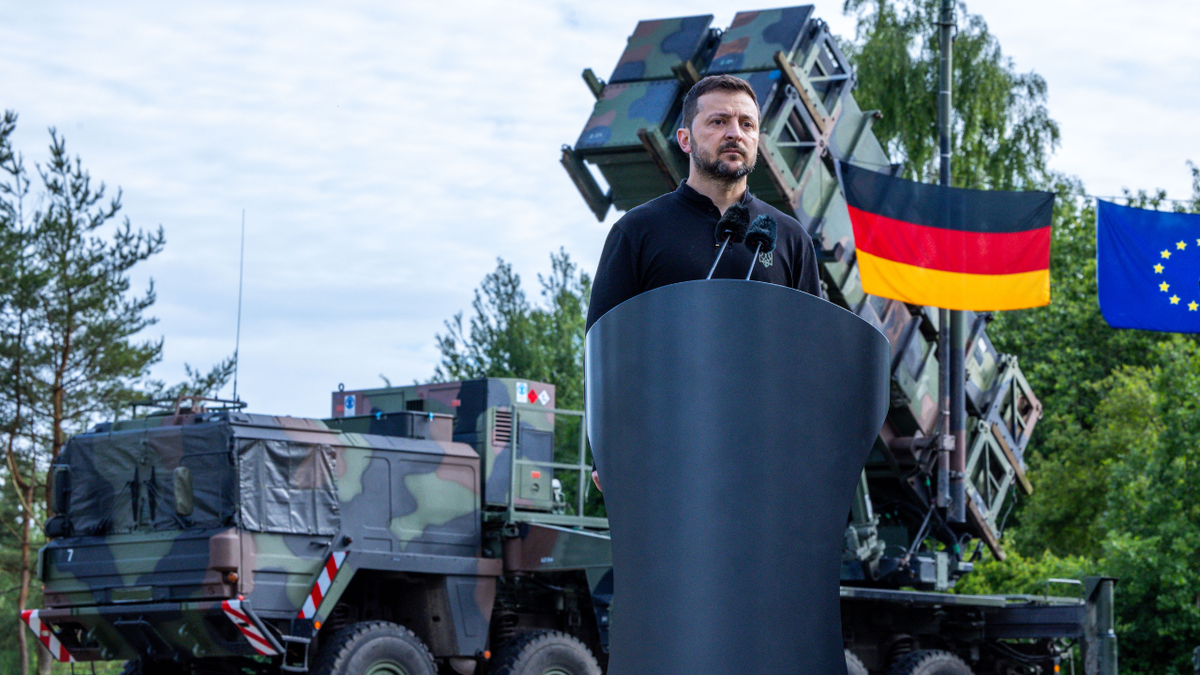 President of Ukraine Volodymyr Zelenskyy stands in front of a Patriot missile system