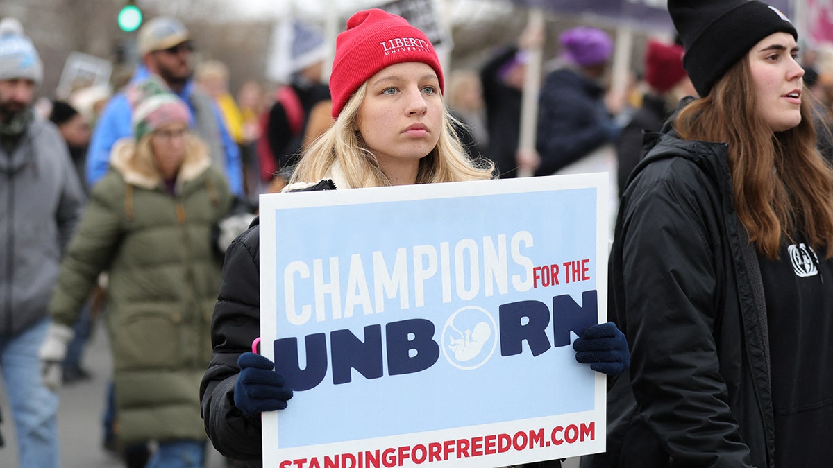 Pro-life protester holds sign