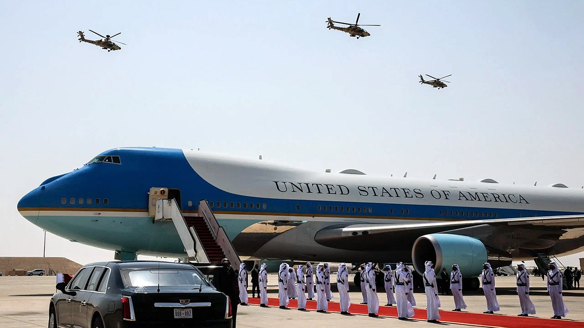 Air Force one on the tarmac with military members outside