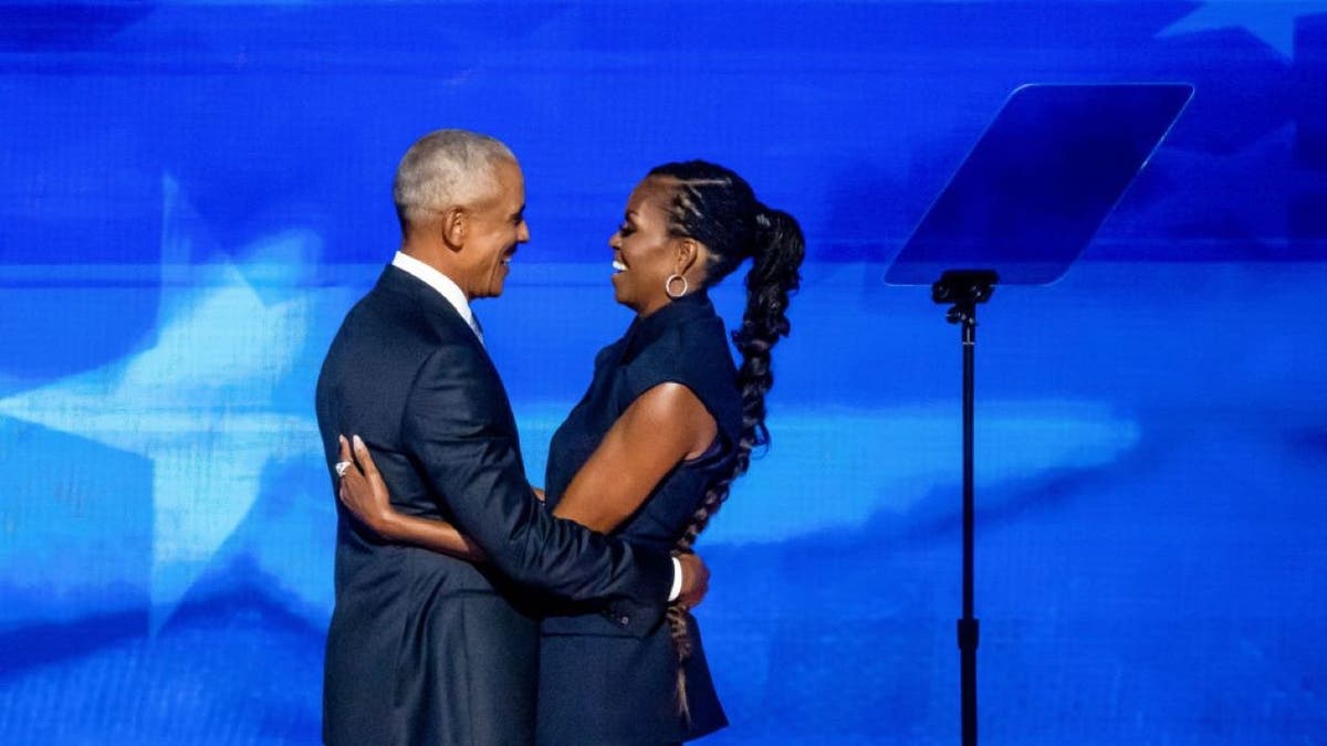 Barack and Michelle Obama embrace