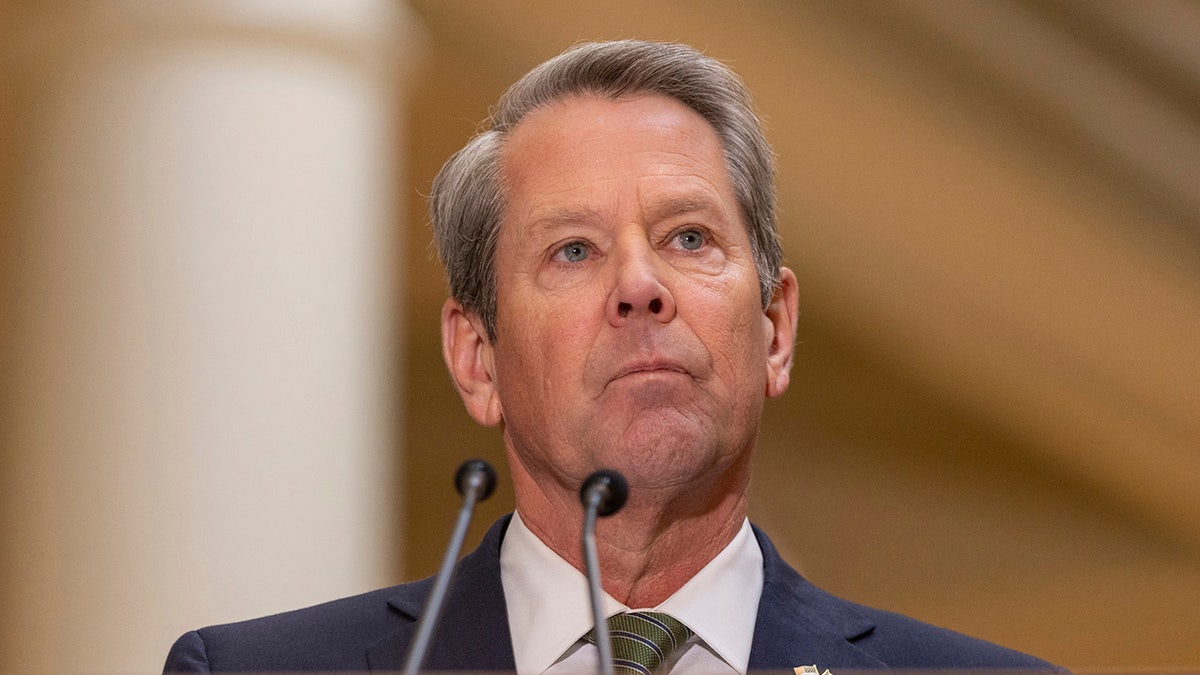 Brian Kemp speaking at a podium