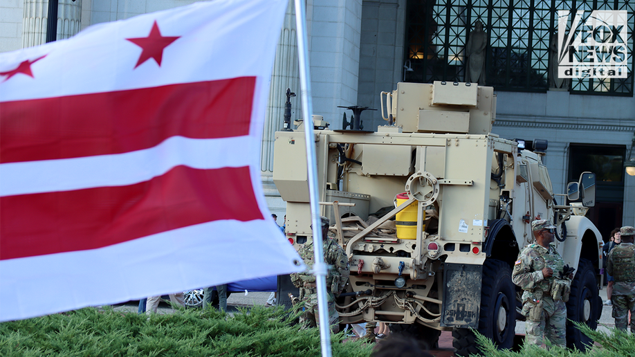 dc flag flies in front of national guard